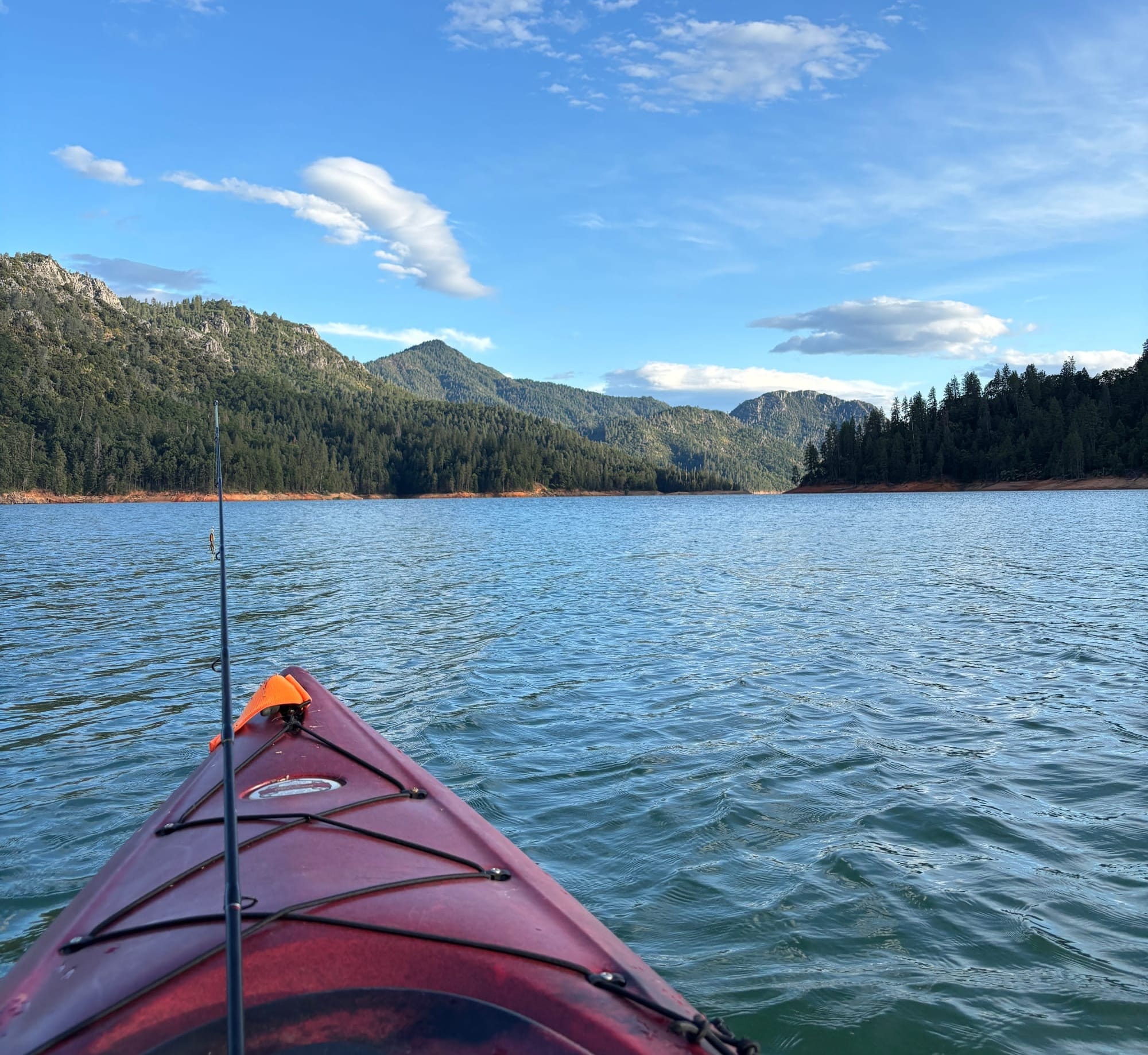 Red kayak with a fishing rod in Lake Shasta